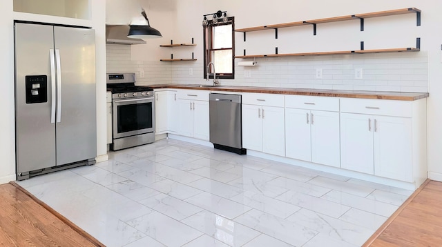 kitchen featuring marble finish floor, open shelves, stainless steel appliances, white cabinets, and under cabinet range hood