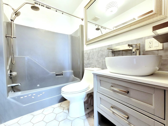 bathroom with tile walls, shower / bath combination, visible vents, toilet, and vanity