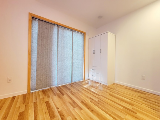 unfurnished bedroom with light wood-style floors and baseboards