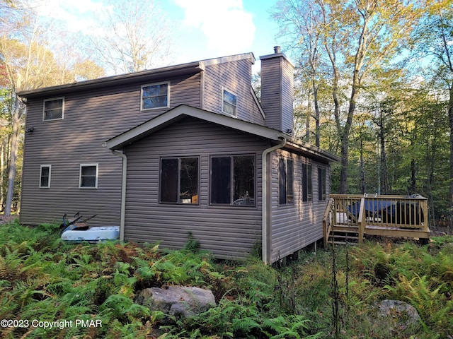 21 Cherry Ct, Clifton Township, PA 18424 - view of home's exterior with a chimney and a deck