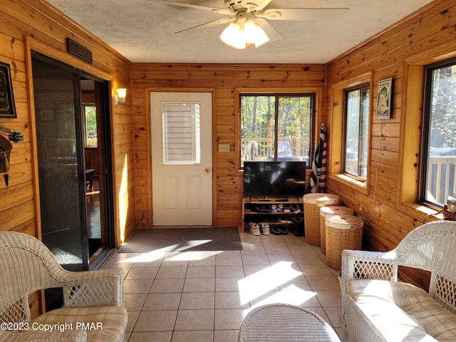 21 Cherry Ct, Clifton Township, PA 18424 - living room with wood walls, a ceiling fan, and light tile patterned flooring