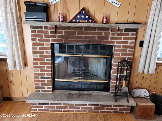 21 Cherry Ct, Clifton Township, PA 18424 - detailed view of a fireplace, wood finished floors, and wooden walls