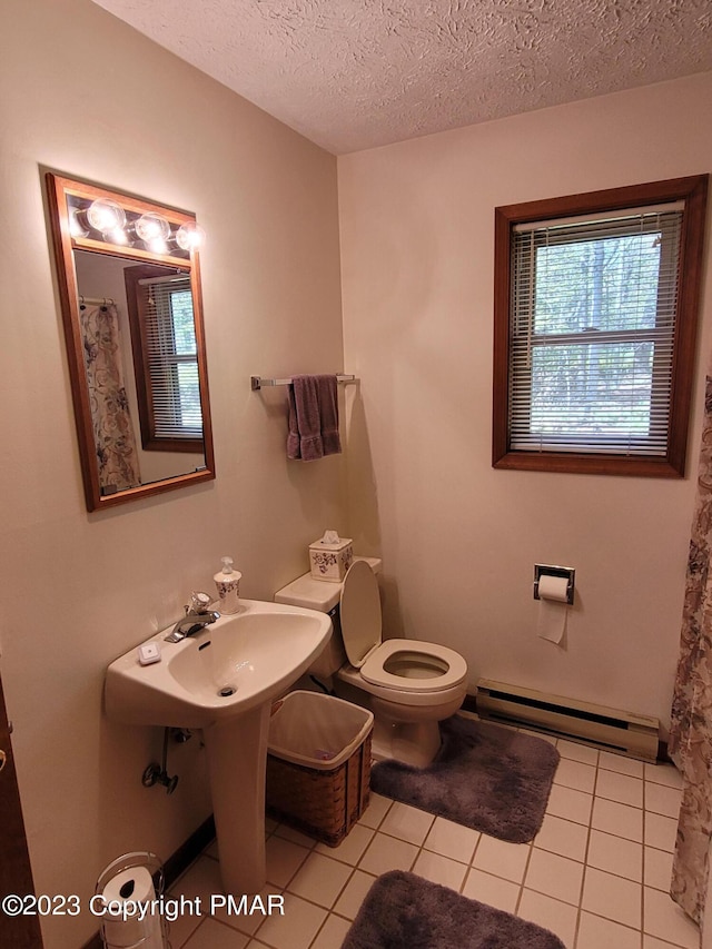 21 Cherry Ct, Clifton Township, PA 18424 - full bathroom featuring a baseboard heating unit, toilet, tile patterned floors, a textured ceiling, and curtained shower