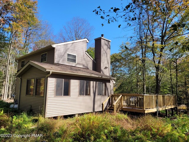 21 Cherry Ct, Clifton Township, PA 18424 - rear view of house featuring a wooden deck and a chimney