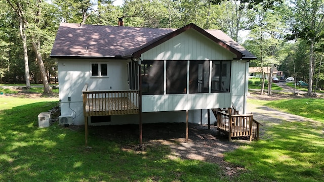 371 Ridge Cir, Cresco, PA 18326 - back of property featuring a sunroom, a shingled roof, a yard, and view of scattered trees