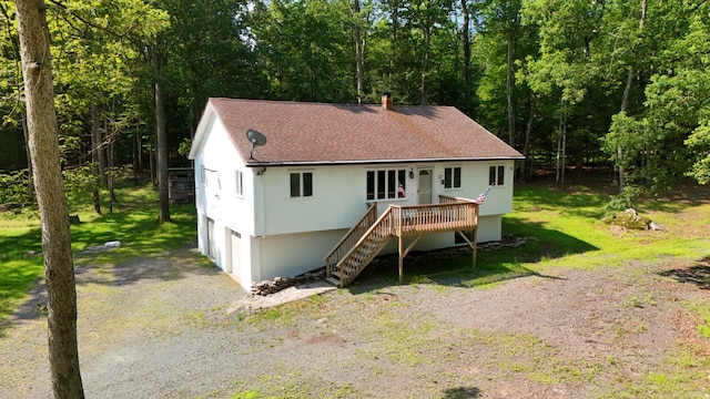 371 Ridge Cir, Cresco, PA 18326 - view of front of home with a shingled roof, stairway, a wooden deck, an attached garage, and stucco siding