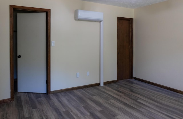 371 Ridge Cir, Cresco, PA 18326 - unfurnished bedroom with a wall mounted air conditioner and dark wood finished floors