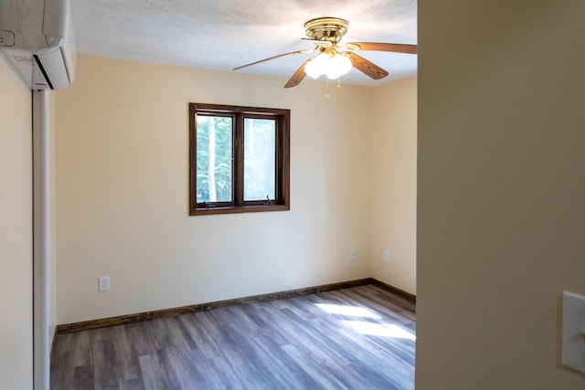 371 Ridge Cir, Cresco, PA 18326 - unfurnished room featuring a wall unit AC, wood finished floors, a ceiling fan, and a textured ceiling