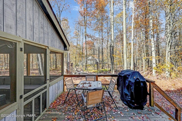 deck featuring grilling area and a sunroom