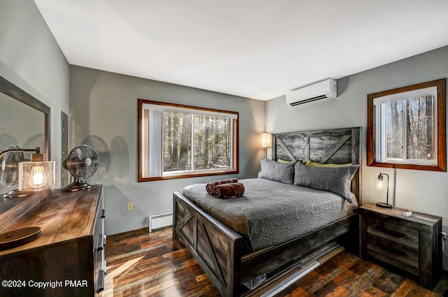 bedroom featuring dark wood-style floors, a baseboard heating unit, and a wall mounted air conditioner