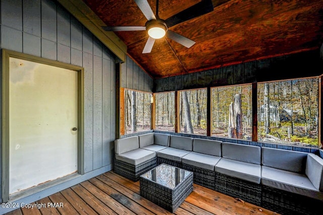 unfurnished sunroom with lofted ceiling, ceiling fan, and wooden ceiling