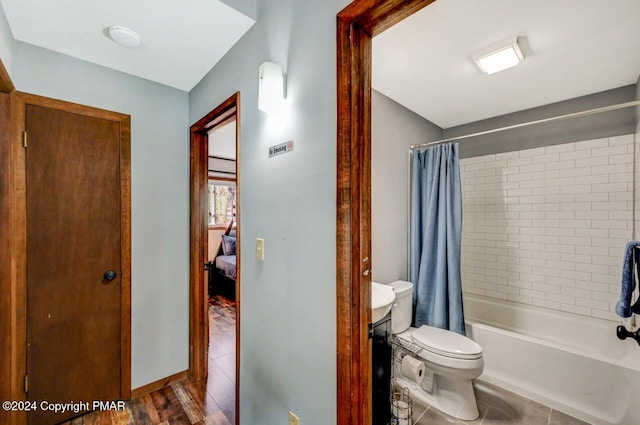 full bath with shower / bath combination with curtain, toilet, and tile patterned floors