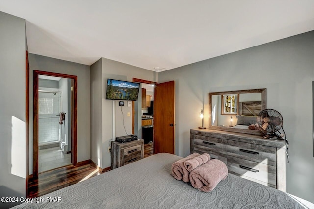 bedroom with wood finished floors and baseboards