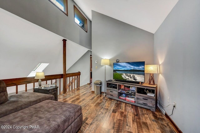 living room with high vaulted ceiling and wood finished floors