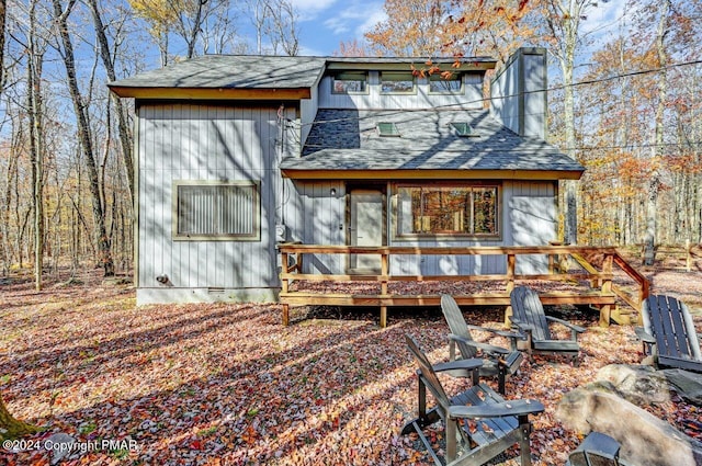 rear view of house featuring crawl space, roof with shingles, and a wooden deck