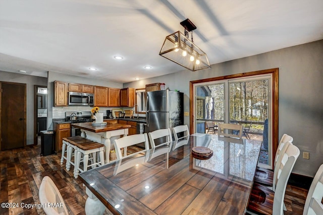 dining area featuring dark wood finished floors and recessed lighting