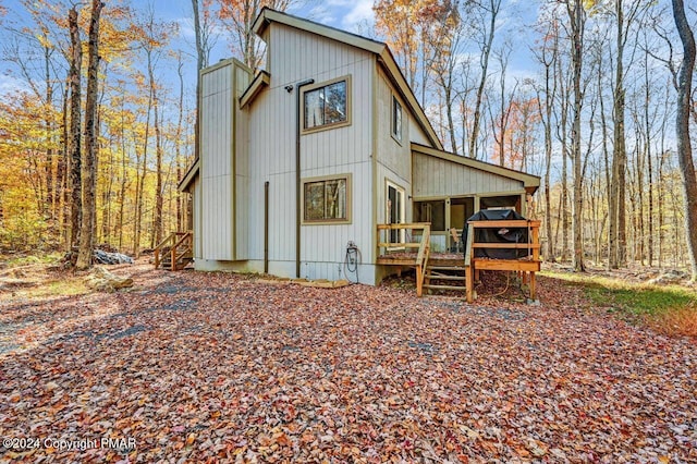 view of front of home featuring a sunroom and a wooden deck