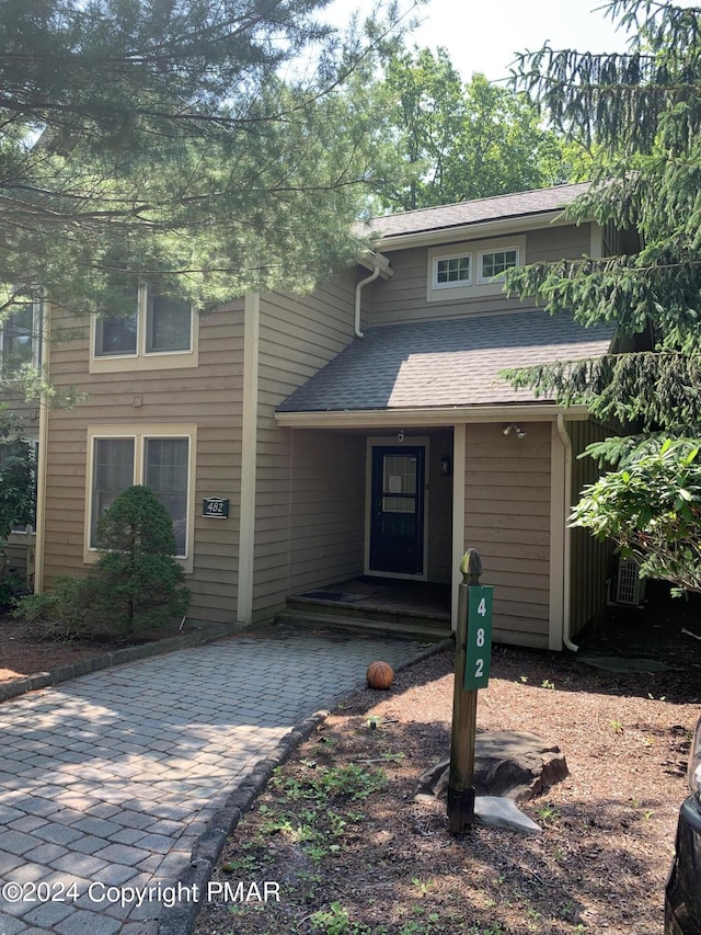 view of front of home featuring covered porch and roof with shingles