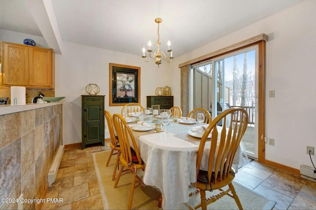 482 Spruce Dr, Tannersville, PA 18372 - dining space featuring stone tile flooring, a notable chandelier, and baseboards