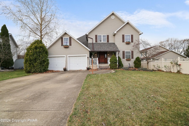 traditional home with a front yard, fence, an attached garage, covered porch, and concrete driveway