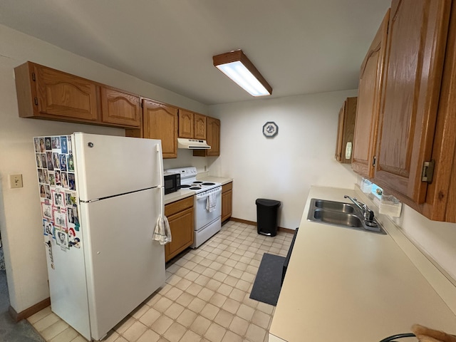 268 Shawnee Dr, East Stroudsburg, PA 18302 - kitchen with white appliances, under cabinet range hood, light countertops, and brown cabinetry