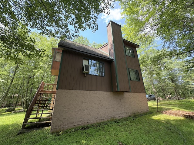 268 Shawnee Dr, East Stroudsburg, PA 18302 - view of home's exterior with a yard, stairway, a chimney, and stucco siding