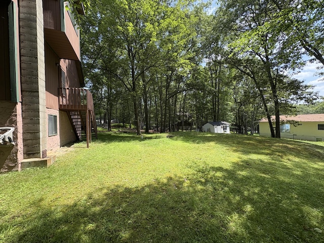 268 Shawnee Dr, East Stroudsburg, PA 18302 - view of green lawn featuring stairs, a storage shed, and a wooden deck