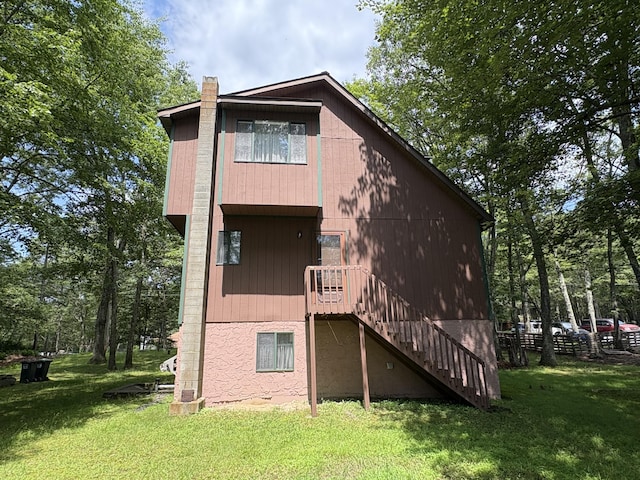 268 Shawnee Dr, East Stroudsburg, PA 18302 - rear view of property with stairs, a lawn, and a chimney