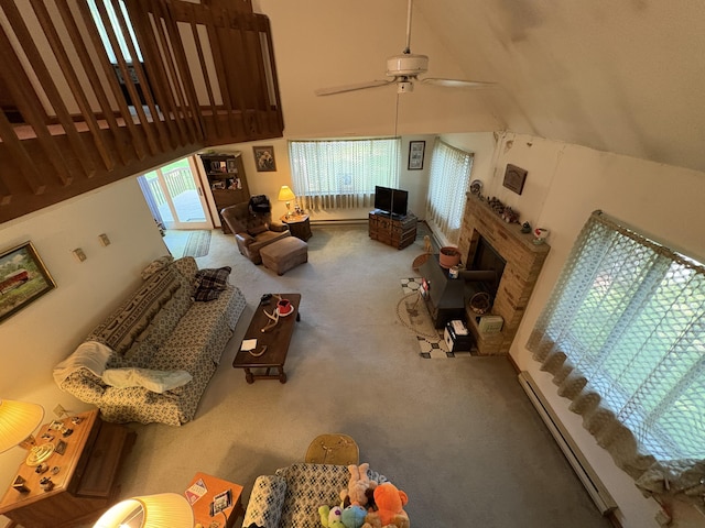 268 Shawnee Dr, East Stroudsburg, PA 18302 - carpeted living room featuring a baseboard heating unit, plenty of natural light, a ceiling fan, high vaulted ceiling, and a fireplace
