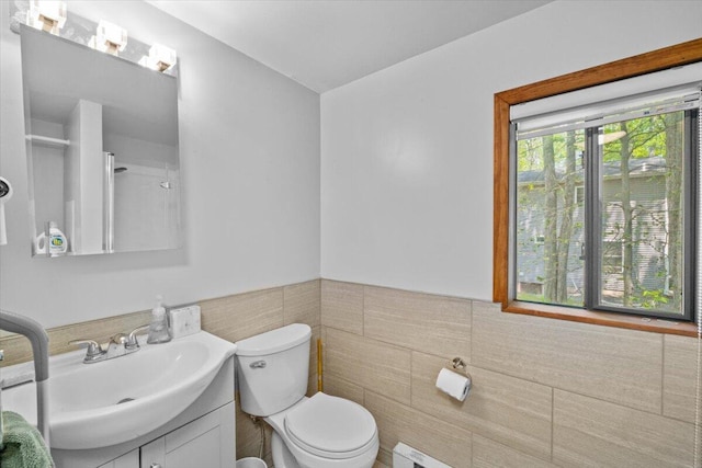 206 Maxatawny Dr, Pocono Lake, PA 18347 - bathroom featuring tile walls, vanity, toilet, and wainscoting