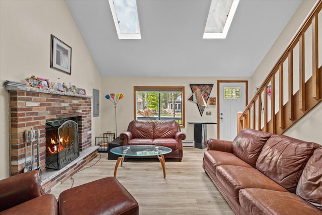 206 Maxatawny Dr, Pocono Lake, PA 18347 - living room with a skylight, a brick fireplace, light wood-type flooring, stairs, and a baseboard heating unit