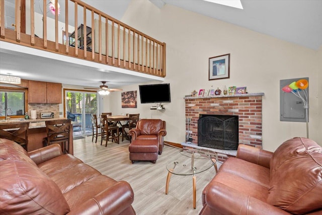 206 Maxatawny Dr, Pocono Lake, PA 18347 - living room with light wood finished floors, high vaulted ceiling, a brick fireplace, a ceiling fan, and baseboards