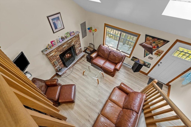 206 Maxatawny Dr, Pocono Lake, PA 18347 - living area with wood finished floors, a skylight, plenty of natural light, a brick fireplace, and vaulted ceiling