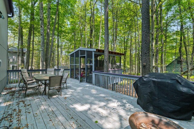 206 Maxatawny Dr, Pocono Lake, PA 18347 - deck featuring a sunroom, outdoor dining space, and grilling area