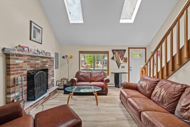 206 Maxatawny Dr, Pocono Lake, PA 18347 - living room with a skylight, a brick fireplace, light wood-style floors, stairway, and a baseboard radiator