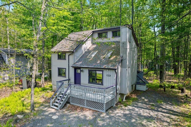 206 Maxatawny Dr, Pocono Lake, PA 18347 - view of front of home with roof with shingles, a wooden deck, and a wooded view