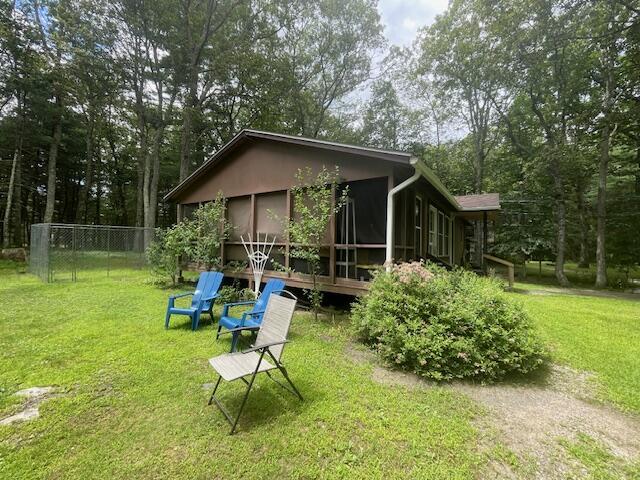 107 Cottonwood Ln, Dingmans Ferry, PA 18328 - rear view of house featuring a sunroom