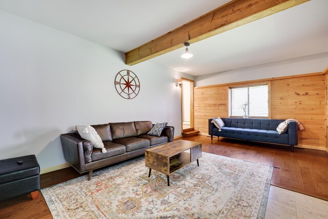 143 Cathleen Dr, East Stroudsburg, PA 18302 - living area featuring beamed ceiling, wooden walls, baseboards, and wood finished floors
