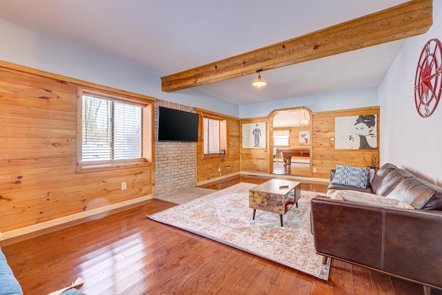 143 Cathleen Dr, East Stroudsburg, PA 18302 - living area with wood walls, wood finished floors, beamed ceiling, and baseboards