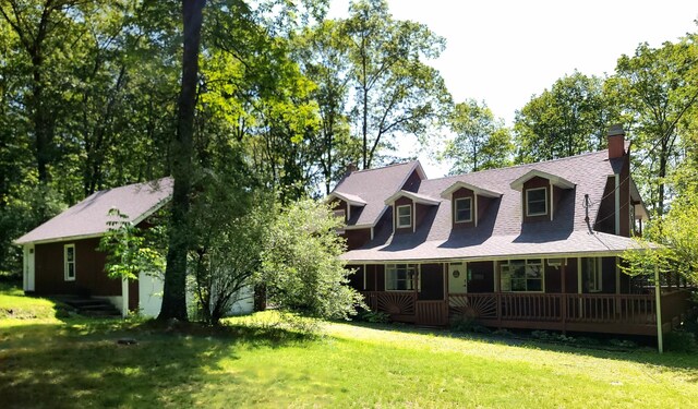 143 Cathleen Dr, East Stroudsburg, PA 18302 - view of front of house featuring a porch, a front lawn, and a chimney