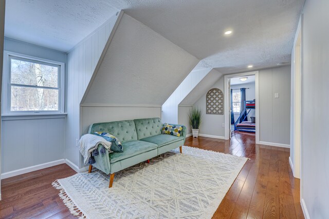 143 Cathleen Dr, East Stroudsburg, PA 18302 - living area featuring a textured ceiling, hardwood / wood-style flooring, baseboards, and lofted ceiling