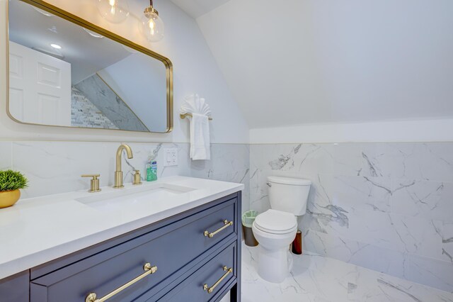 143 Cathleen Dr, East Stroudsburg, PA 18302 - bathroom featuring marble look tile flooring, vanity, toilet, tile walls, and a wainscoted wall