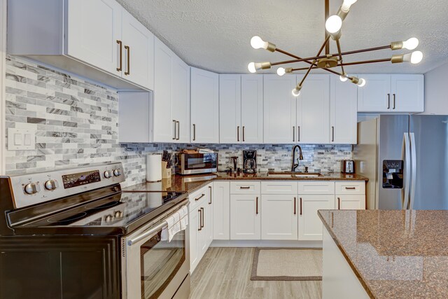 143 Cathleen Dr, East Stroudsburg, PA 18302 - kitchen featuring appliances with stainless steel finishes, a sink, white cabinetry, and a textured ceiling
