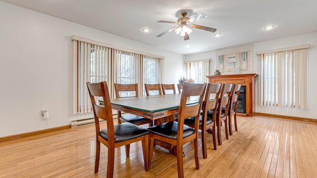 dining area featuring baseboards, recessed lighting, light wood-style floors, a ceiling fan, and a baseboard radiator