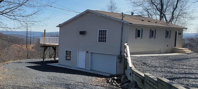 rear view of property with an attached garage