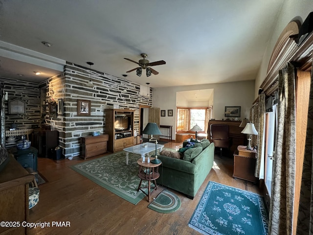 living area with ceiling fan and wood finished floors