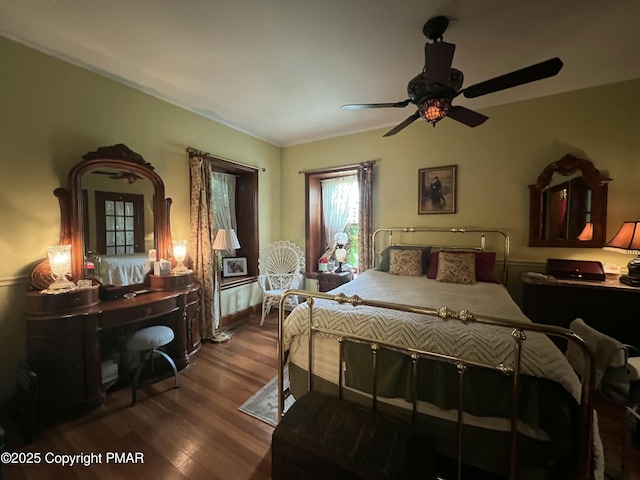 bedroom with wood finished floors and a ceiling fan