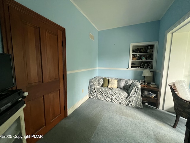 bedroom with carpet floors, baseboards, visible vents, and crown molding