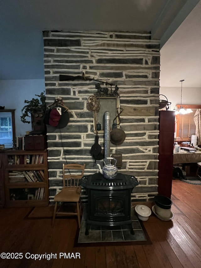 interior details with a wood stove and wood finished floors