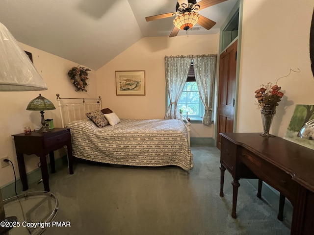 carpeted bedroom with a ceiling fan and vaulted ceiling